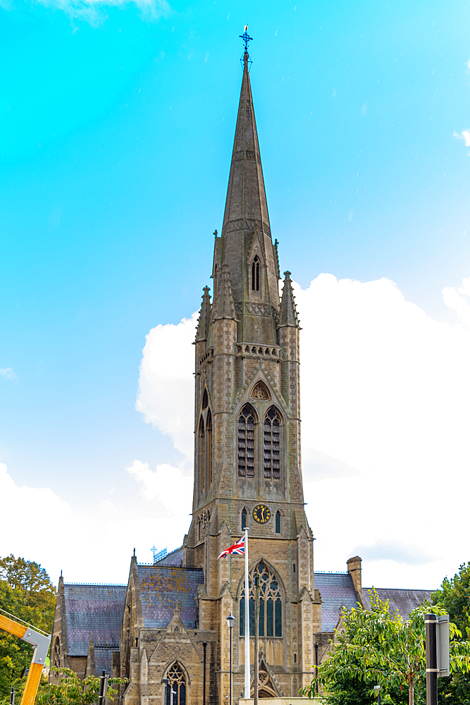 Gothic church spire of St. John's Church against a blue sky with clouds, Bath, Somerset, England, United Kingdom, Europe