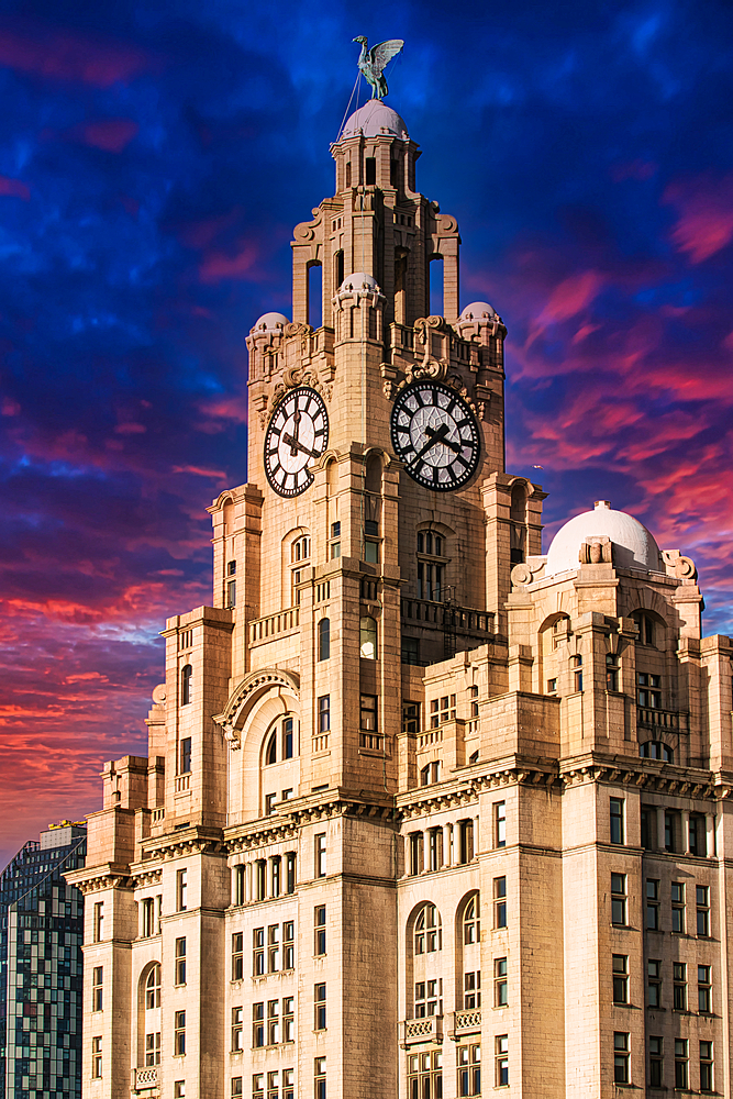 Liver Building in Liverpool, UK against a dramatic sunset sky