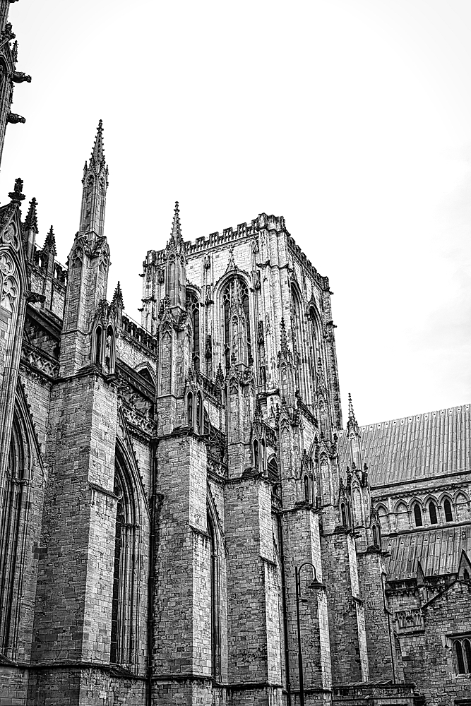 Black and white photo of a Gothic cathedral with intricate stone carvings and tall spires.