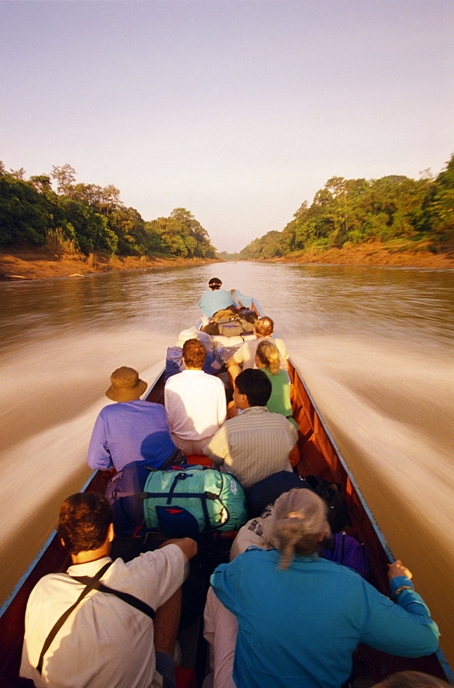 Tourists in longboat on a river in the Mulu National Park in Sarawak, Borneo, Malaysia, Southeast Asia, Asia