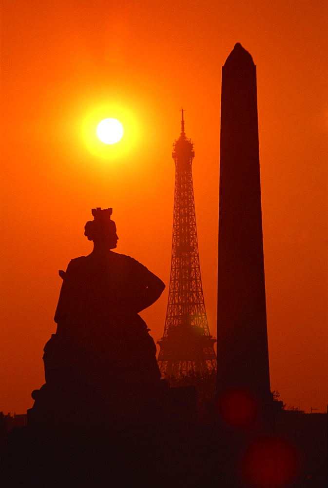 The Eiffel Tower, the Luxor Obelisk, 3200 years old, from Egypt, and the Strasbourg statue silhouetted at sunset, Place de la Concorde, Paris, France, Europe