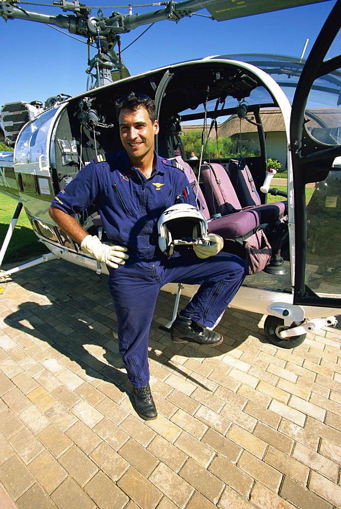 A pilot with his helicopter in Wonder Valley, Central Drakensberg, South Africa, Africa