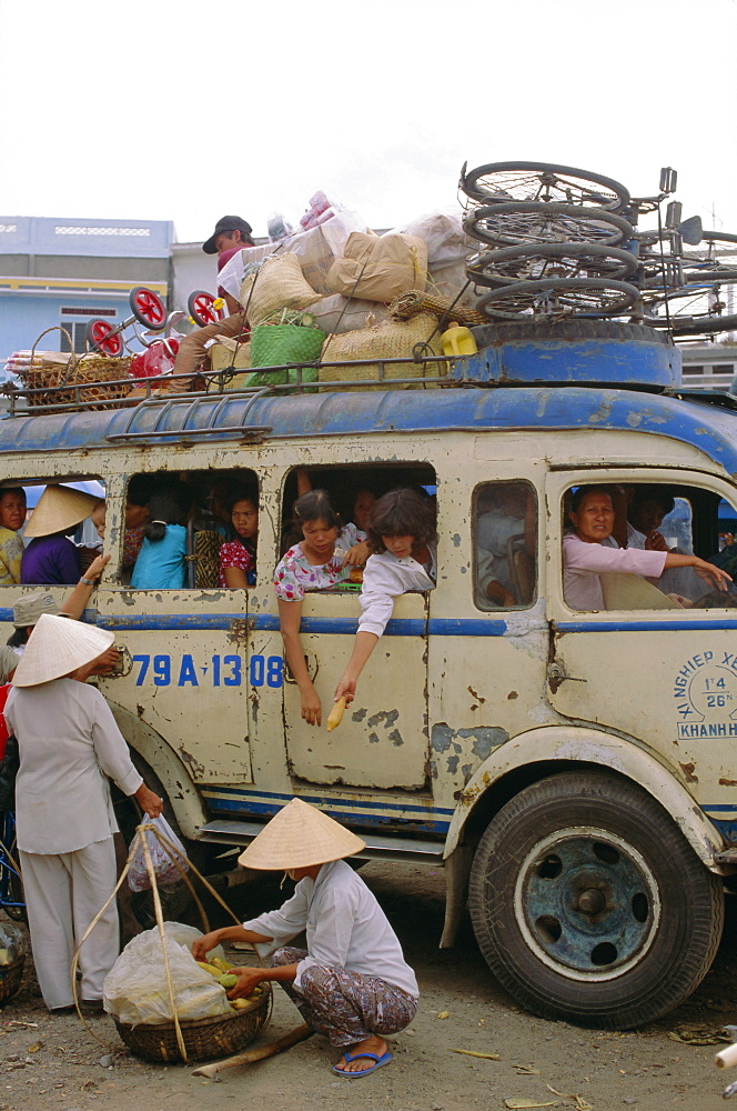 Crowded bus with bicycles, sacks and passengers on roof, city bus terminal, Nha Trang, Vietnam, Indochina, Southeast Asia, Asia