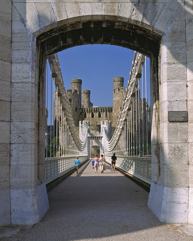 Telford Suspension Bridge, opened in 1826, leading to Conwy Castle, UNESCO World Heritage Site, beyond, North Wales, United Kingdom, Europe