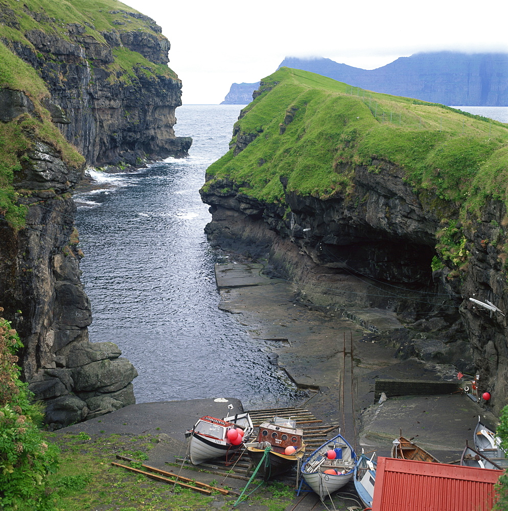 Fishing boats in a cove at Gjogv, Estoroy Island, Faroe Islands, Denmark, Europe