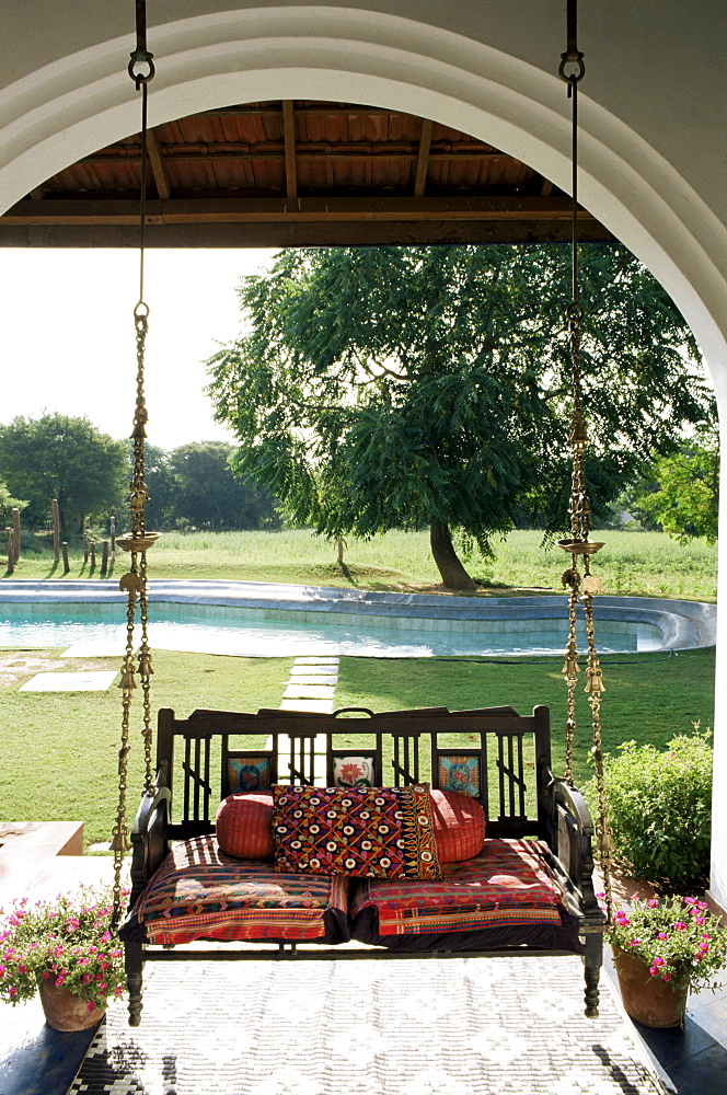 A swing chair Hitchkar traditional and particular to Gujarat, plus traditional fabrics in a residential home, near Ahmedabad, Gujarat state, India, Asia