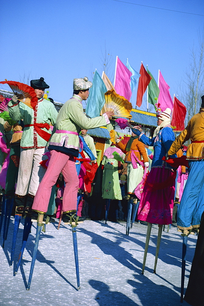 Crowds of stilt dancers celebrate Chinese New Year, China, Asia