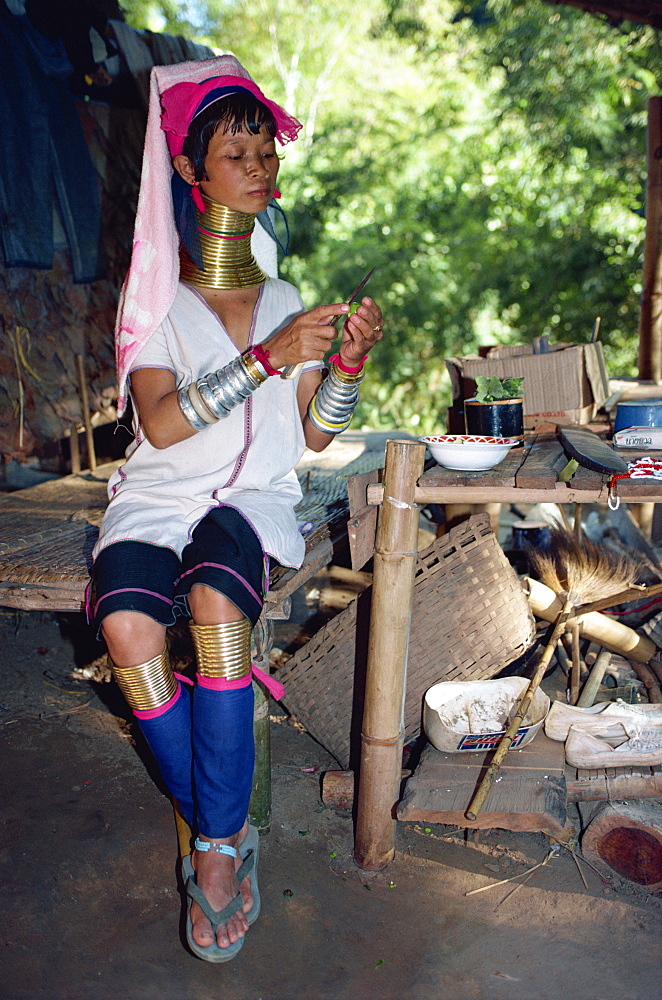 Long necked woman preparing food on the Thai-Burma border in Thailand, Southeast Asia, Asia