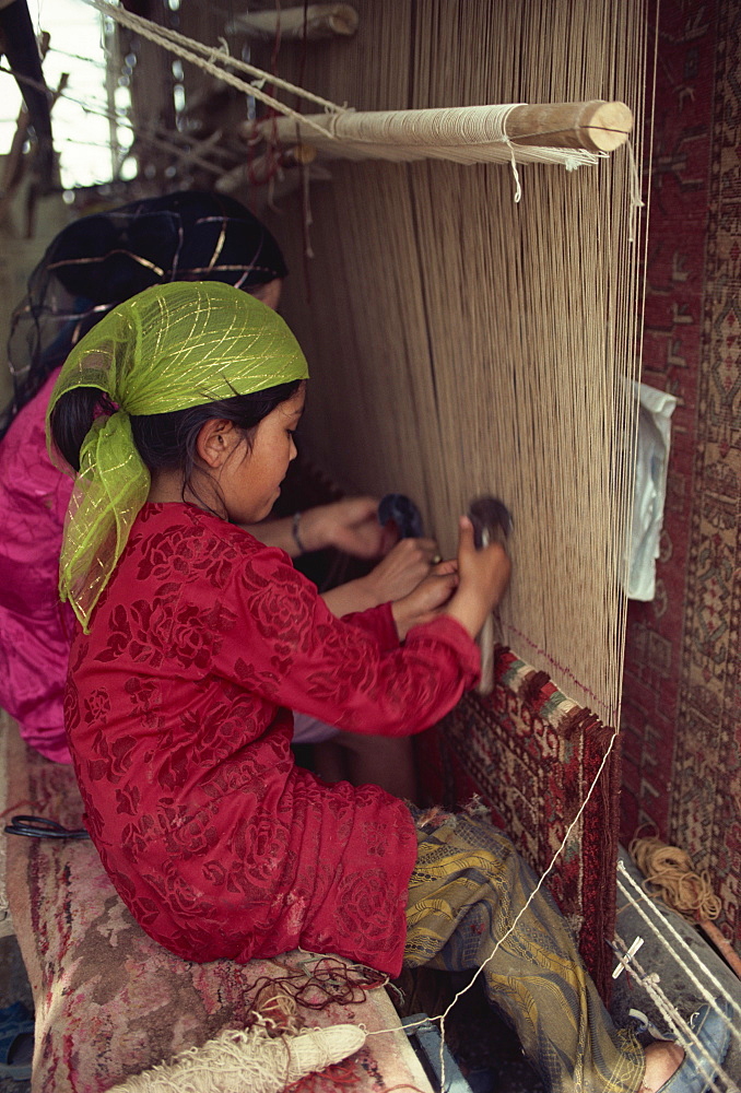 Uyghur children learning to make carpets, Hotan, China, Asia