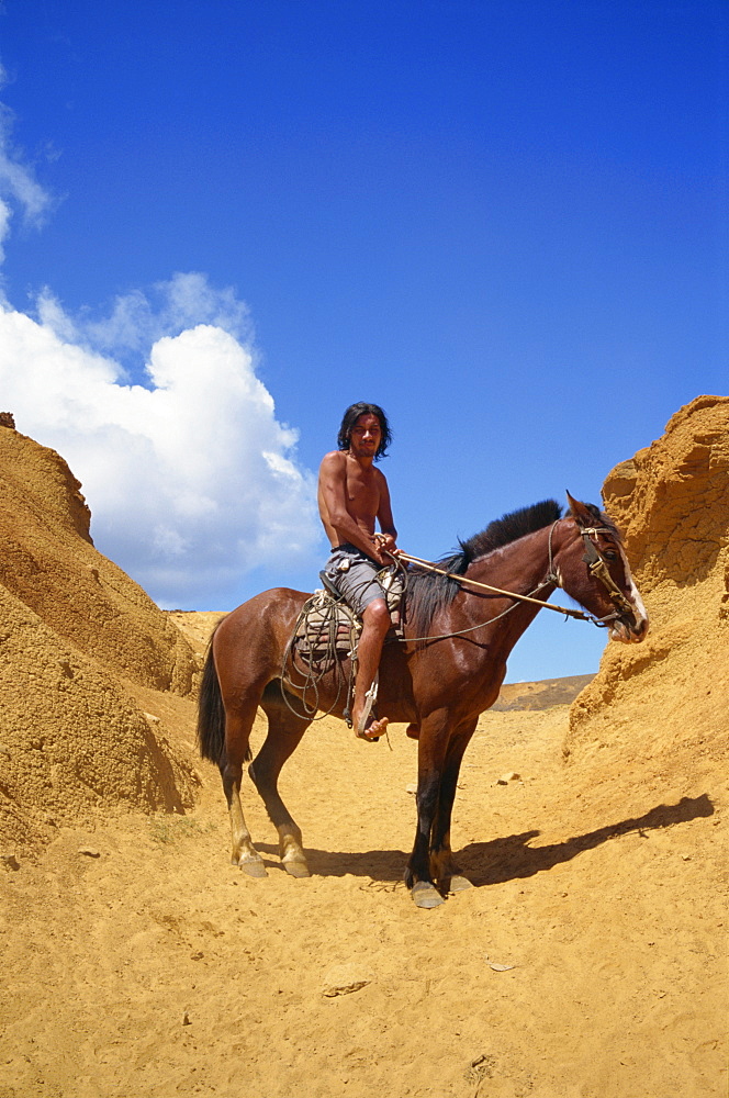 Portrait of Rapa Nui horseman at exit from centre Rano Raraku crater on track along which statues were transported, on Easter Island, Chile, Pacific, South America