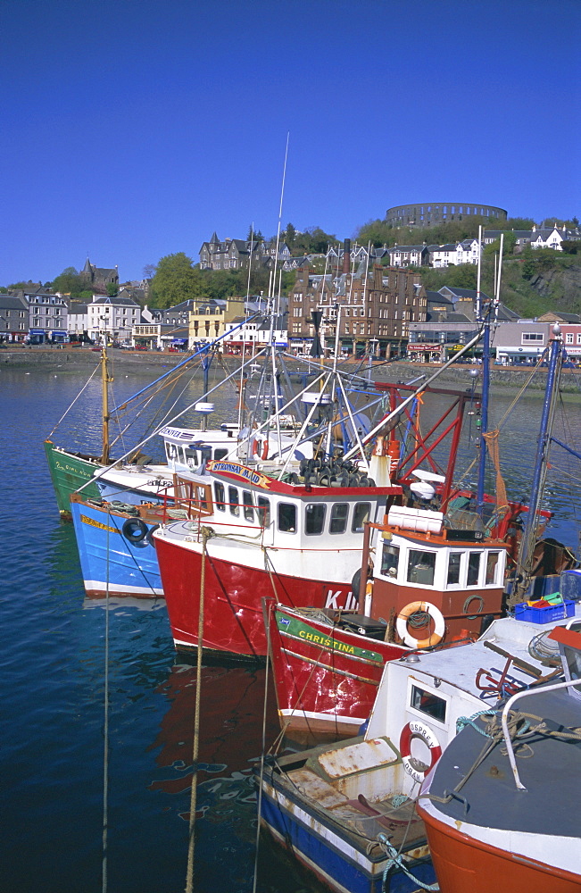 Boats and waterfront, McCaig's Tower on hill, Oban, Argyll, Strathclyde, Scotland, UK, Europe