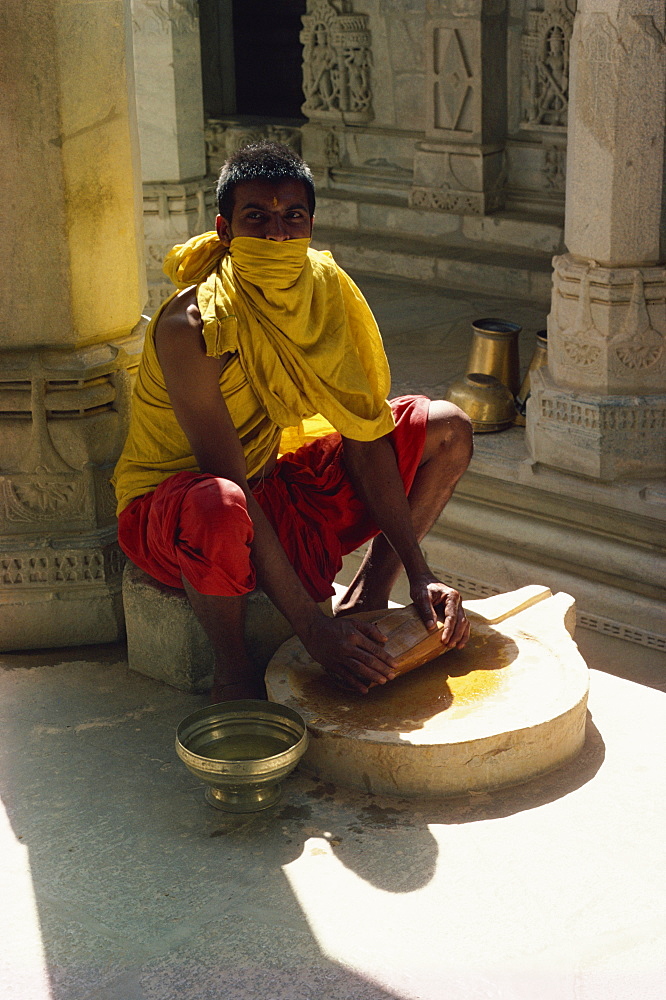 Jain priest making sandalwood paste, Ranakpur, Rajasthan state, India, Asia