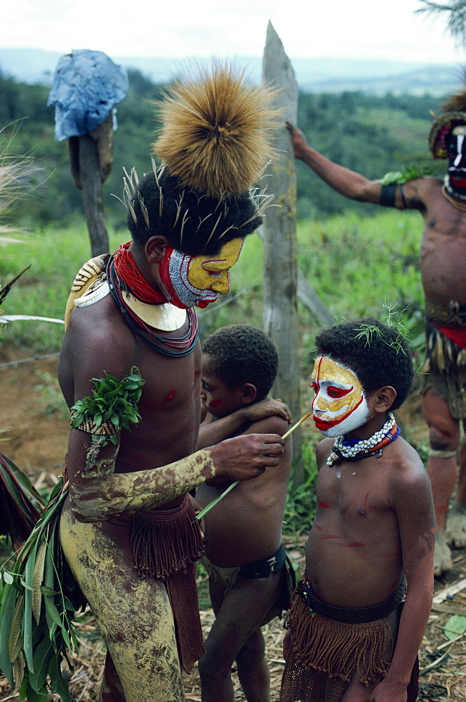 Young boy having his face painted for traditional ceremony, Hul Singsing, Papua New Guinea, Pacific Islands, Pacific