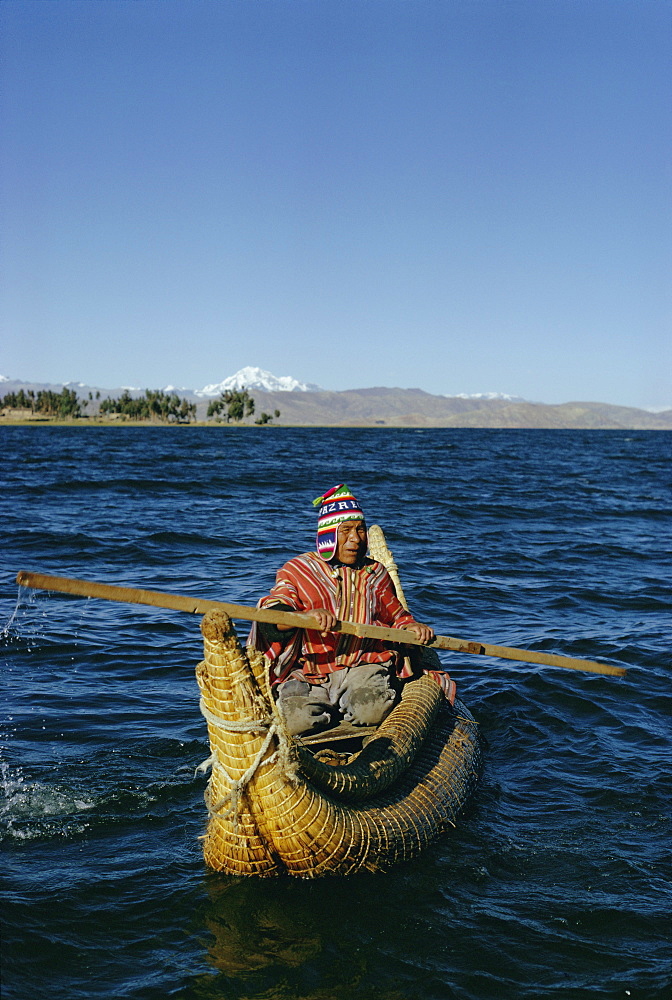 Aymara Indian in a reed boat, Lake Titicaca, Bolivia, South America