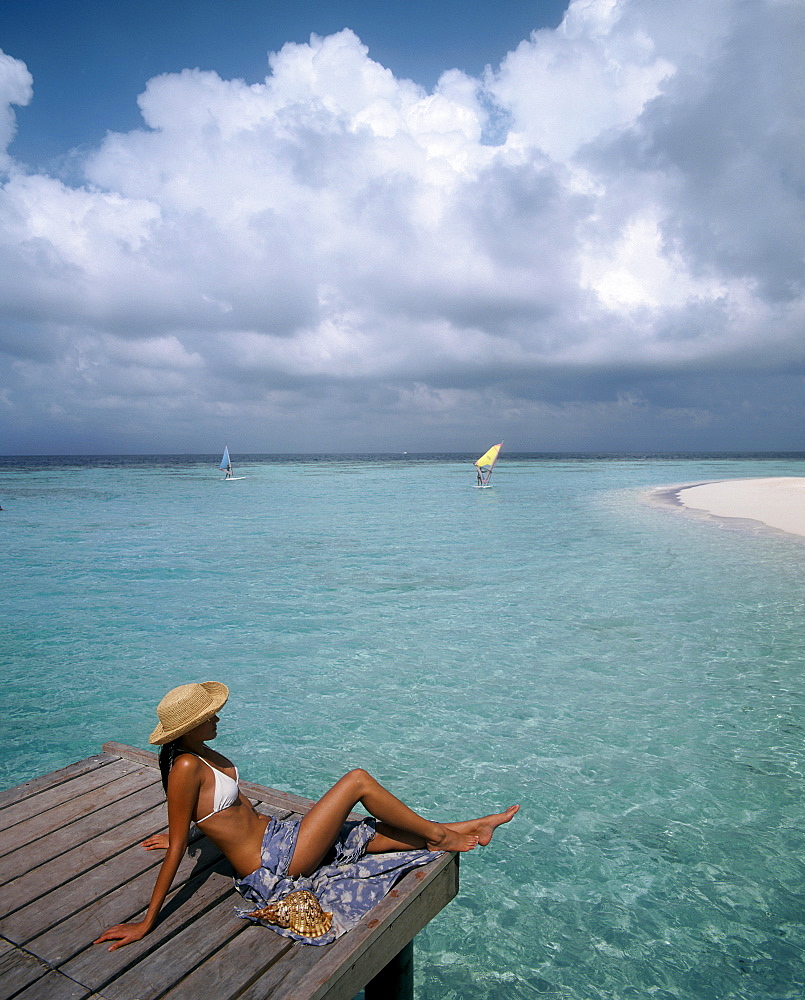 Woman on jetty, Maldives, Indian Ocean, Asia