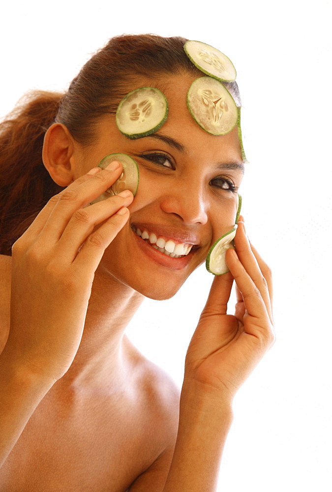 Young woman with cucumber facial 