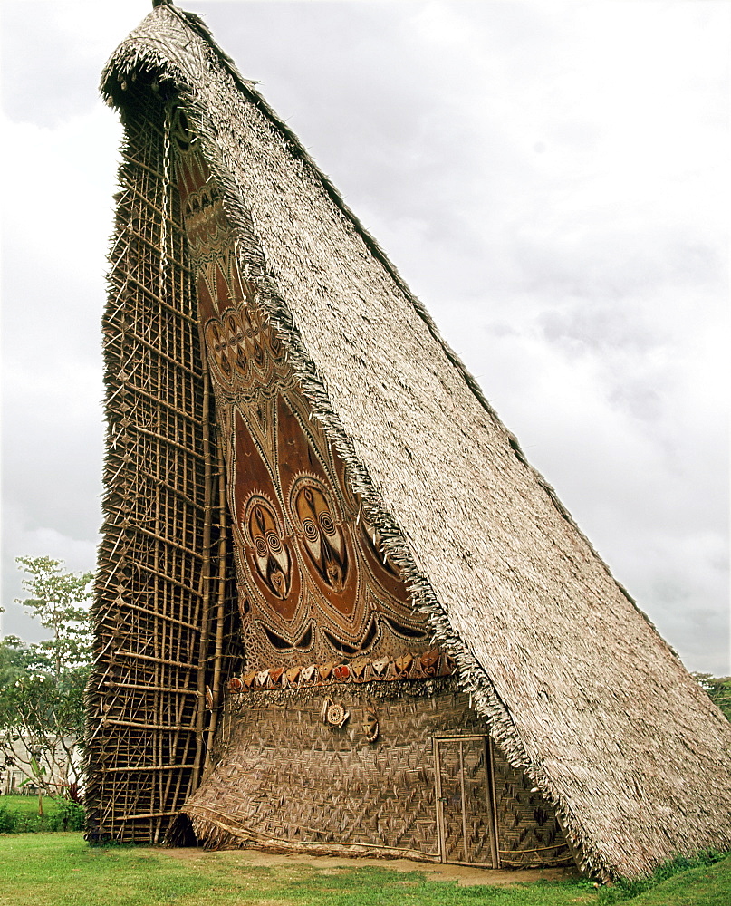 House Tamberan, or ceremonial building, photographed in 1974, only initiated warriors were allowed inside and in the days of cannibalism, a victim's head from a neighbouring tribe was hung above the entrance as a warning to those not properly initiated, Maprik, Sepik River, Papua New Guinea, Pacific