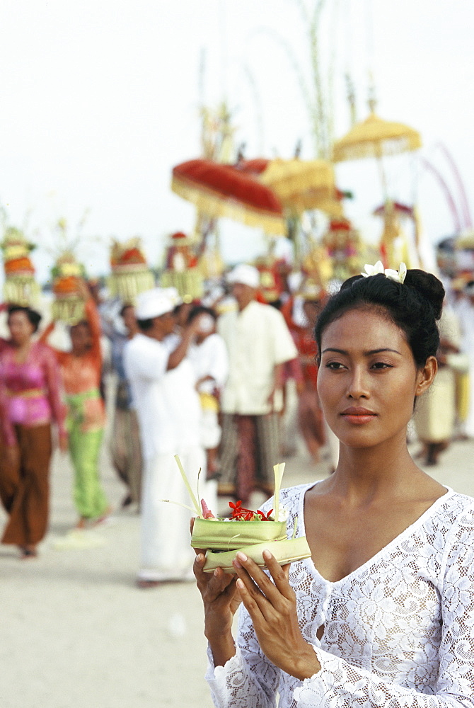 Young woman carrying offering at a ceremony in Bali, Indonesia, Southeast Asia, Asia