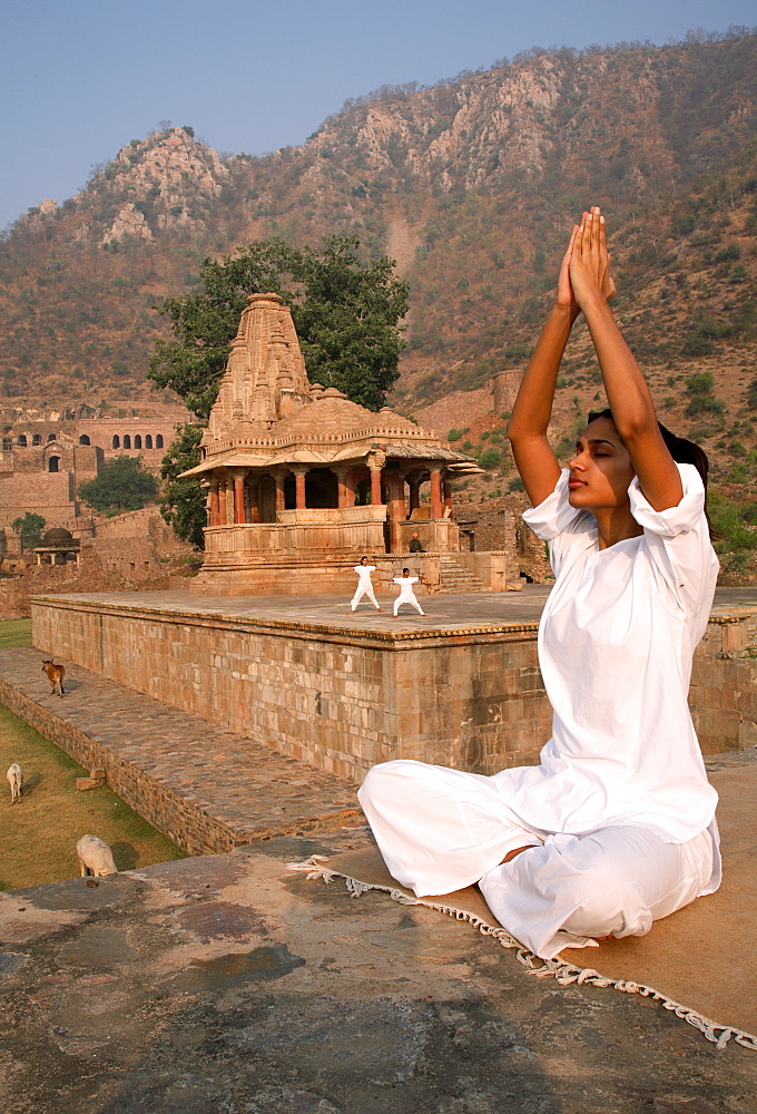 Women practising yoga in the abandoned town of Bhangarh, Alwar, Rajasthan, India, Asia