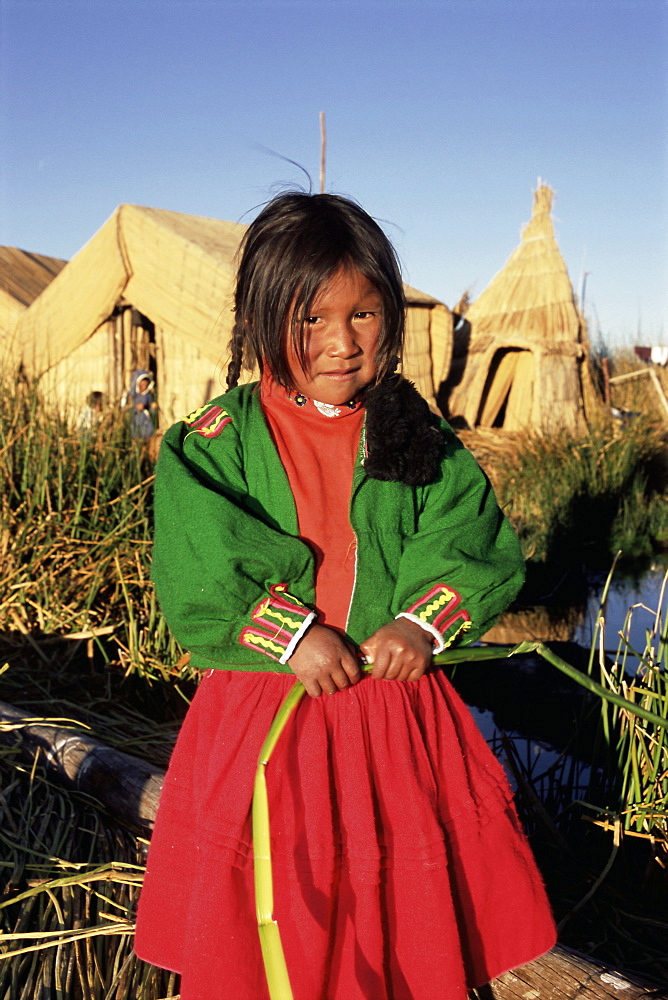 Portrait of a Uros Indian girl on a floading reed island, Islas Flotantes, Lake Titicaca, Peru, South America