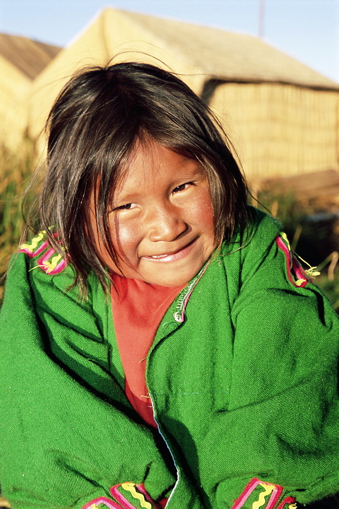 Head and shoulders portrait of a Uros Indian girl on floating reed island, Islas Flotantes, Lake Titicaca, Peru, South America