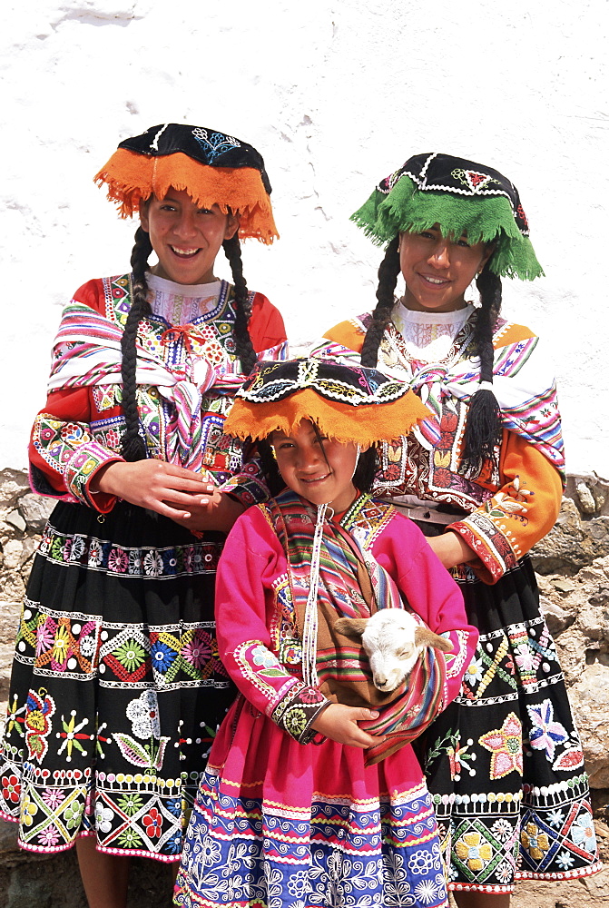 Portrait of three local Peruvian girls in traditional dress, looking at the camera, Cuzco (Cusco), Peru, South America