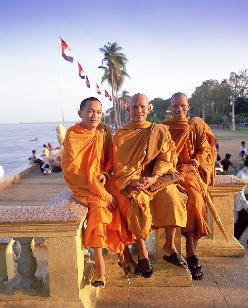 Portrait of three Buddhist monks along the Tonle Sap river in the waterfront area of Phnom Penh, Cambodia, Indochina, Southeast Asia, Asia