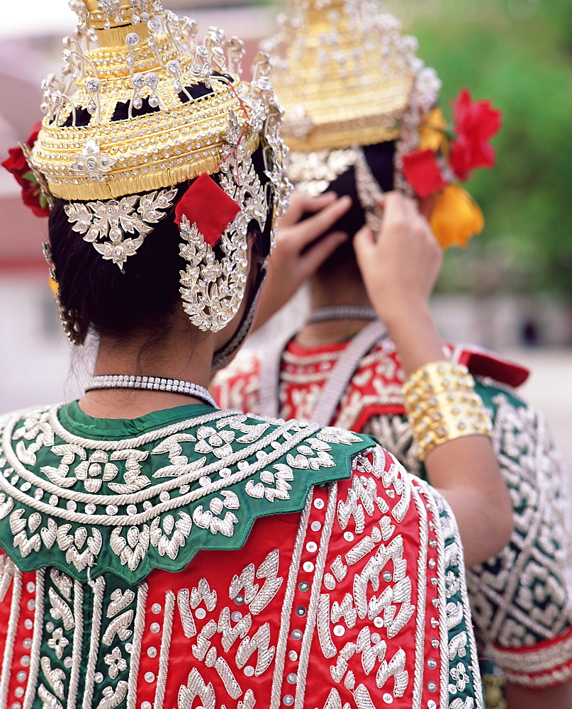 Close-up of the back view of two dancers in traditional Thai classical dance costume, Bangkok, Thailand, Southeast Asia, Asia