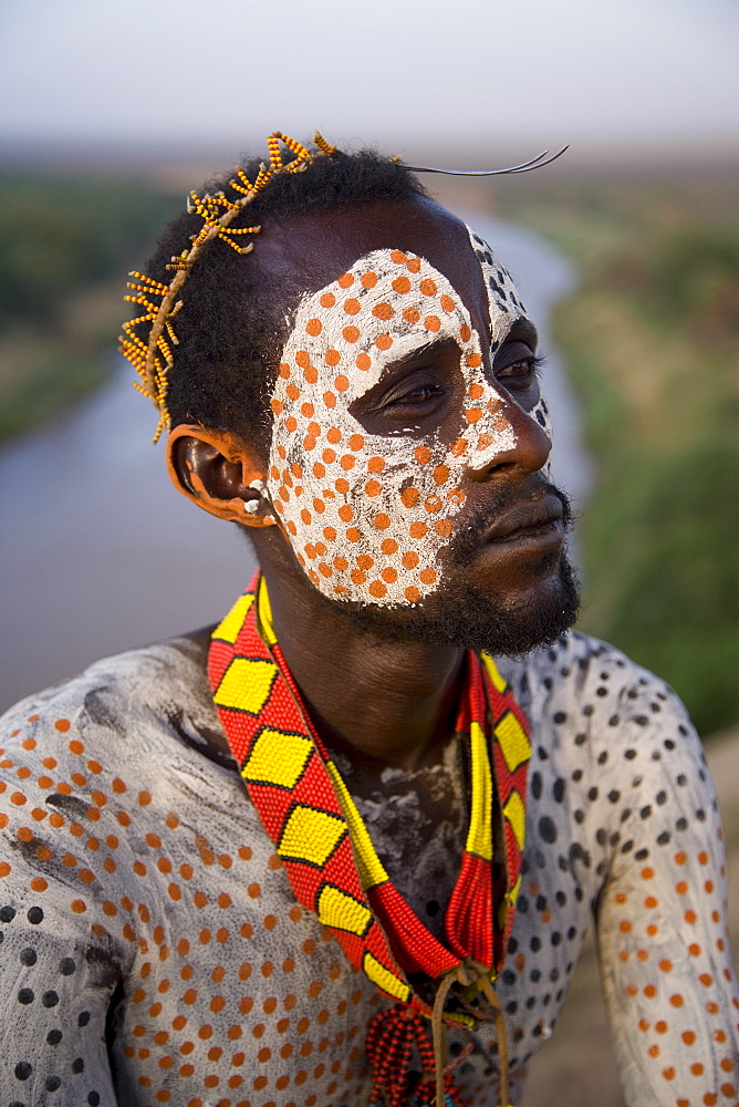 Portrait of a Karo tribesman with facial decoration in chalk imitating the spotted plumage of the guinea fowl, Lower Omo Valley, Ethiopia, Africa