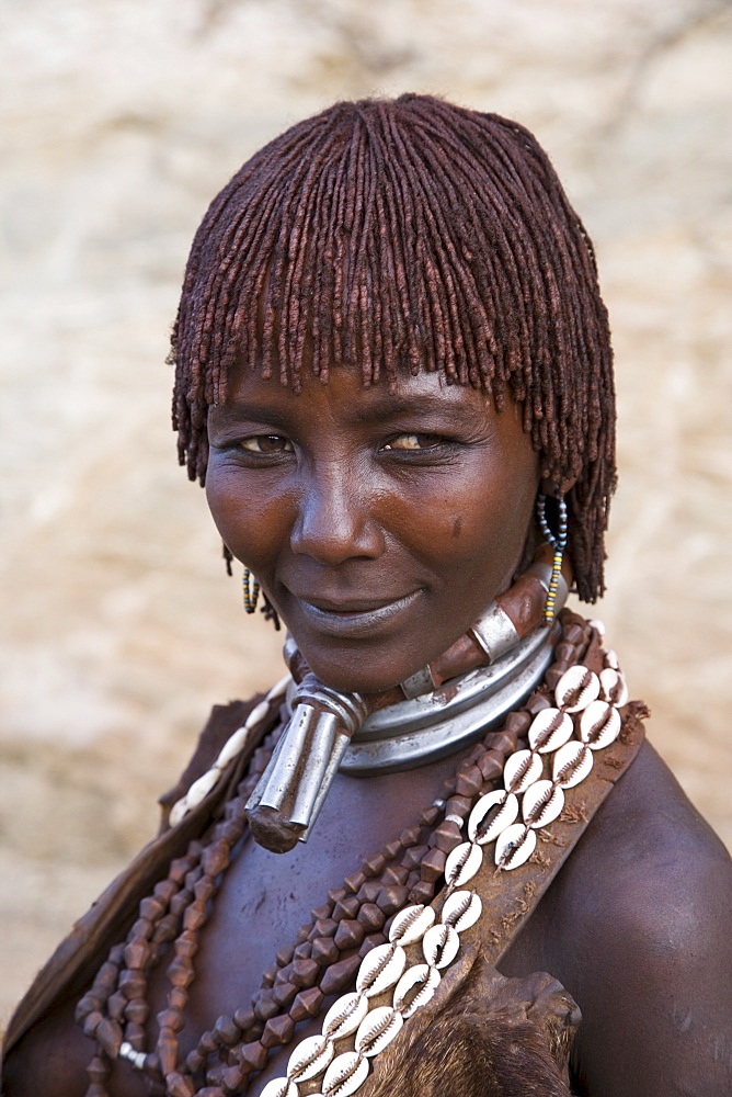 Portrait of a woman of the Hamer tribe, her hair treated with ochre, water and resin and twisted into tresses known as goscha, Lower Omo Valley, Southern Ethiopia, Africa