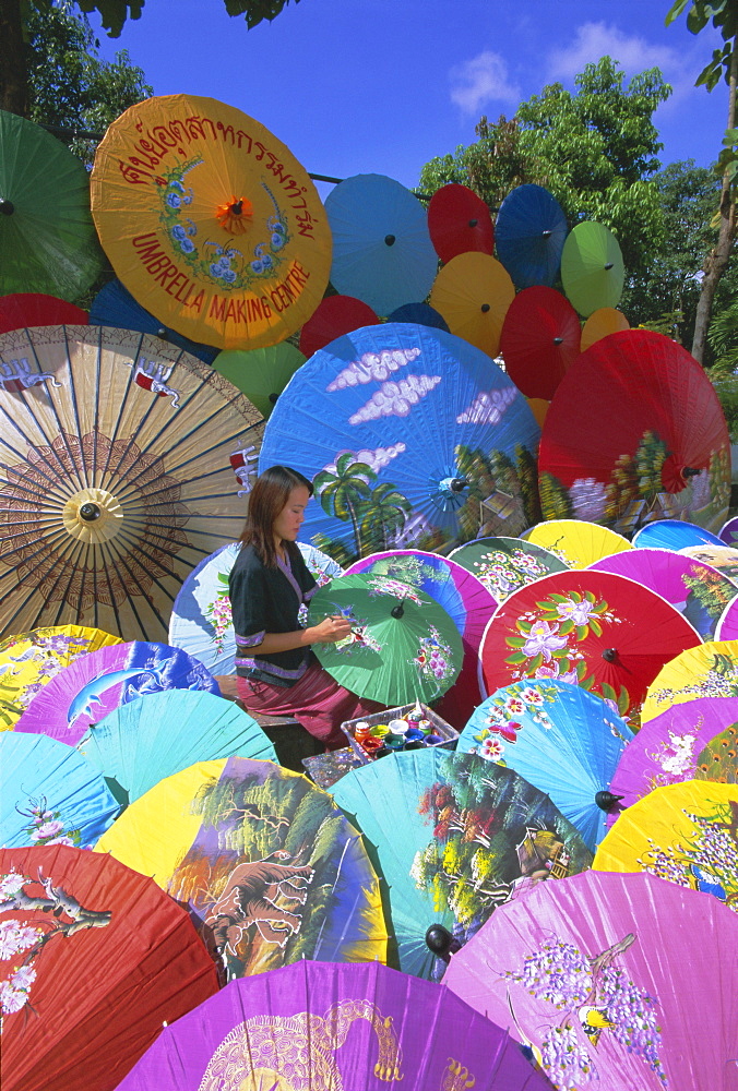 Woman painting umbrellas, Bo Sang umbrella village, Chiang Mai, northern Thailand, Asia