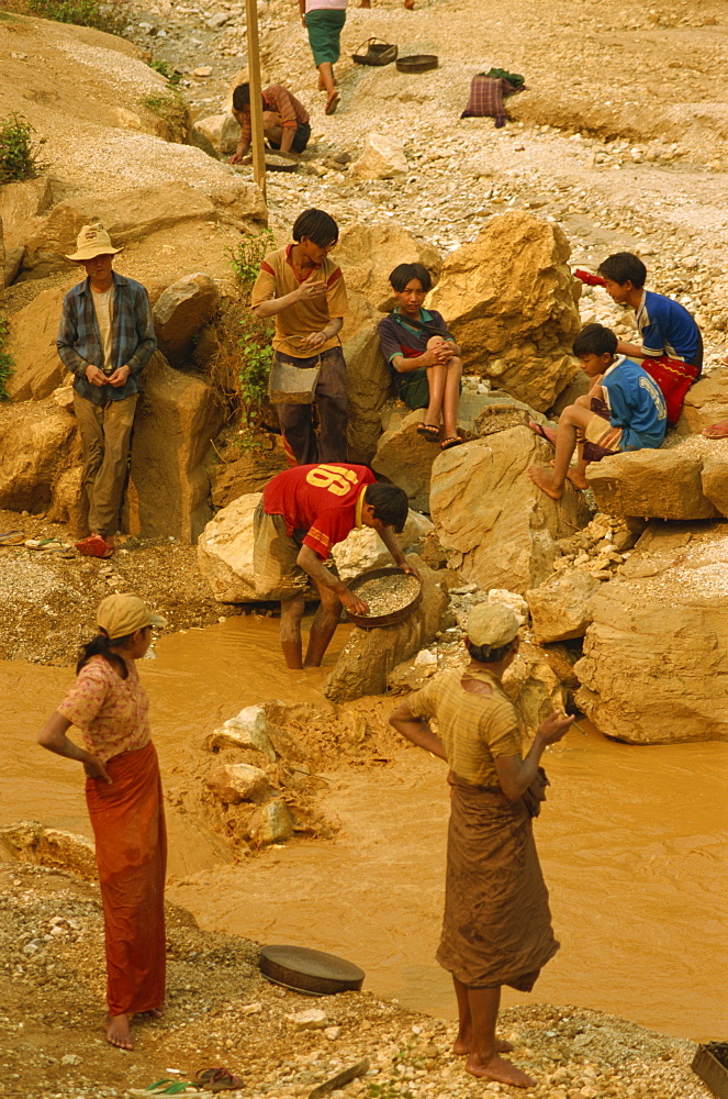 Children sieving and washing small gems from stream below mine, Mogok ruby mines, near Mandalay, Myanmar (Burma), Asia