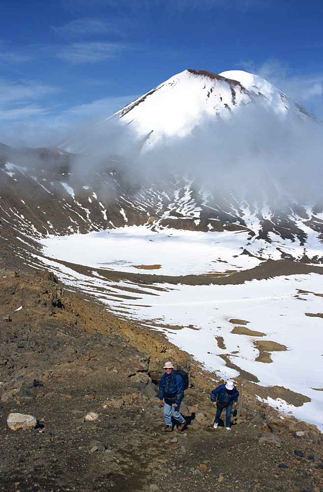 Late winter hikers on Tongariro crossing, Mount Ngauruhoe and South Crater, Taupo, Tongariro National Park, UNESCO World Heritage Site, North Island, New Zealand, Pacific