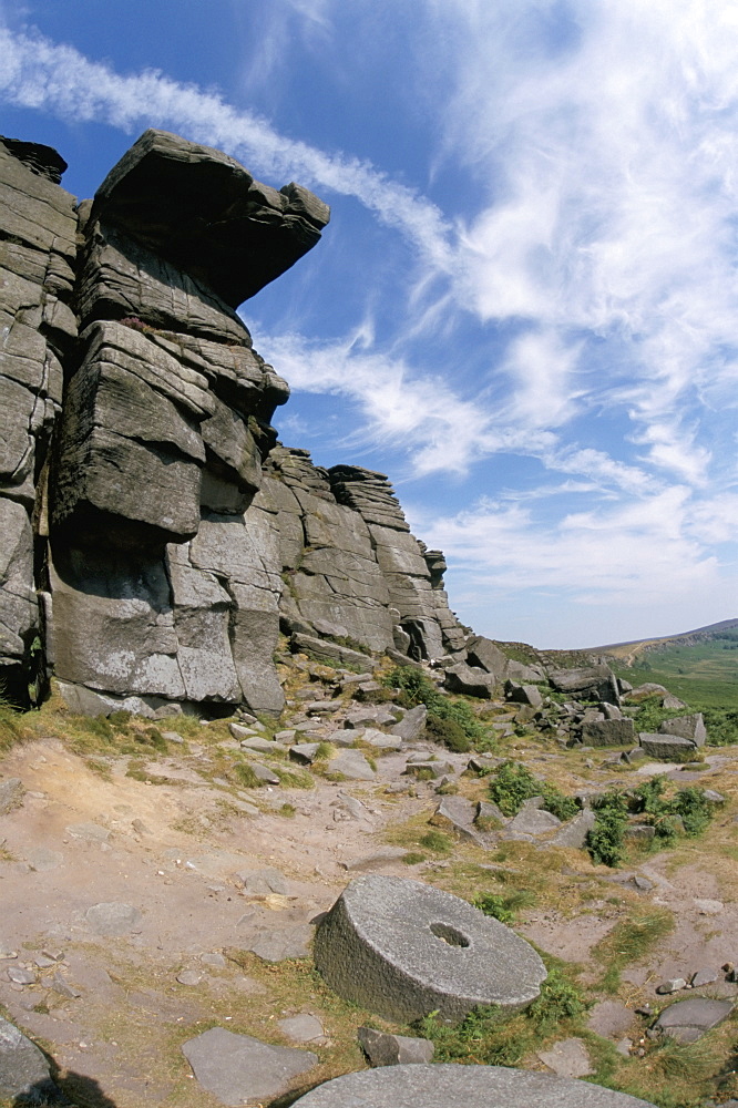 Old millstones left at quarried edge of gritstone (millstone grit), Stanage Edge, Peak District National Park, Derbyshire, England, United Kingdom, Europe