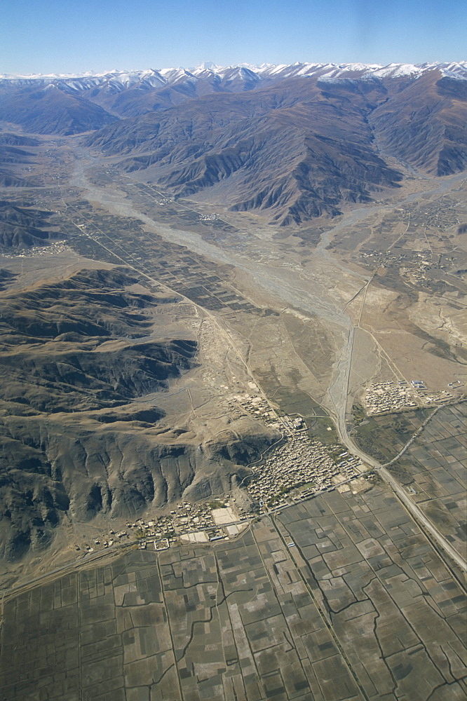 Village beside river on Tibetan Plateau, Tibet, China, Asia