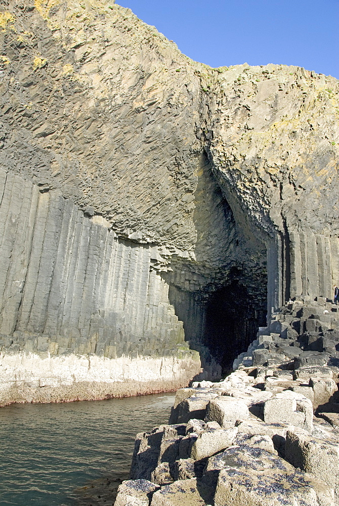 Columnar basalt lava with Fingal's Cave cut into it by sea, Staffa, off west coast of Mull, Inner Hebrides, Scotland, United Kingdom, Europe