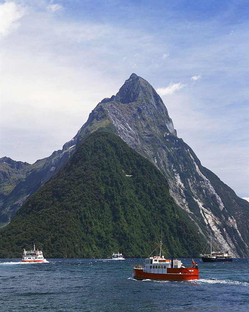 Small boats in the water of Milford Sound in front of Mitre Peak, Otago, South Island, New Zealand, Pacific