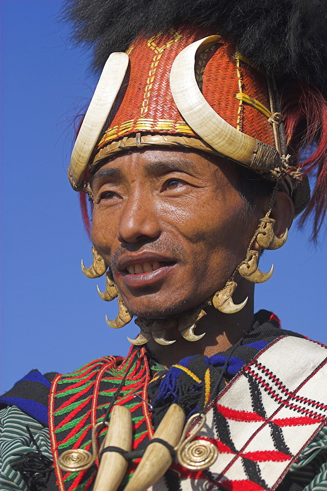 Naga man wearing headdress made of woven cane decorated with wild boar teeth and  bear fur with Tiger claw straps and  wearing tiger teeth necklace, Naga New Year Festival, Lahe village, Sagaing Division, Myanmar (Burma), Asia