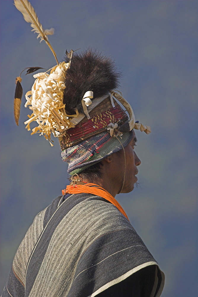 Naga man in headdress of woven cane decorated with wild boar's teeth, bear fur and topped with feathers, Naga New Year Festival, Lahe village, Sagaing Division, Myanmar (Burma), Asia