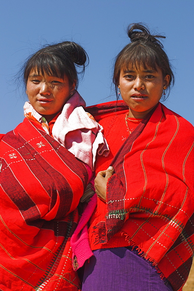 Naga (Macham tribe) girls wrapped up in their traditional blanket, Magyan Village, Sagaing Division, Myanmar (Burma), Asia