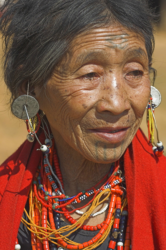 Naga (Macham tribe) lady with face tattoos, done during childhood so that they are not attractive to men who might steal them from their village, Magyan Village, Sagaing Division, Myanmar (Burma), Asia