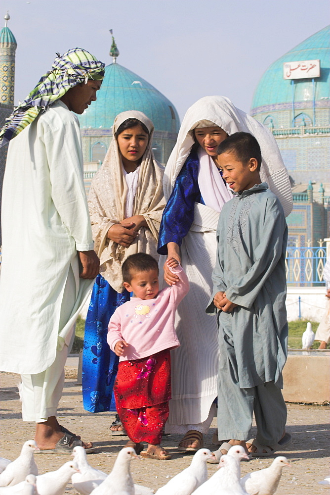 Family looking at famous white pigeons at the shrine of Hazrat Ali, who was assassinated in 661, Mazar-I-Sharif, Balkh province, Afghanistan, Asia