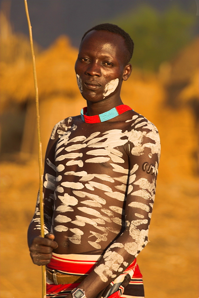 Karo man with body painting, made from mixing animal pigments with clay, at dancing performance, Kolcho village, Lower Omo valley, Ethiopia, Africa