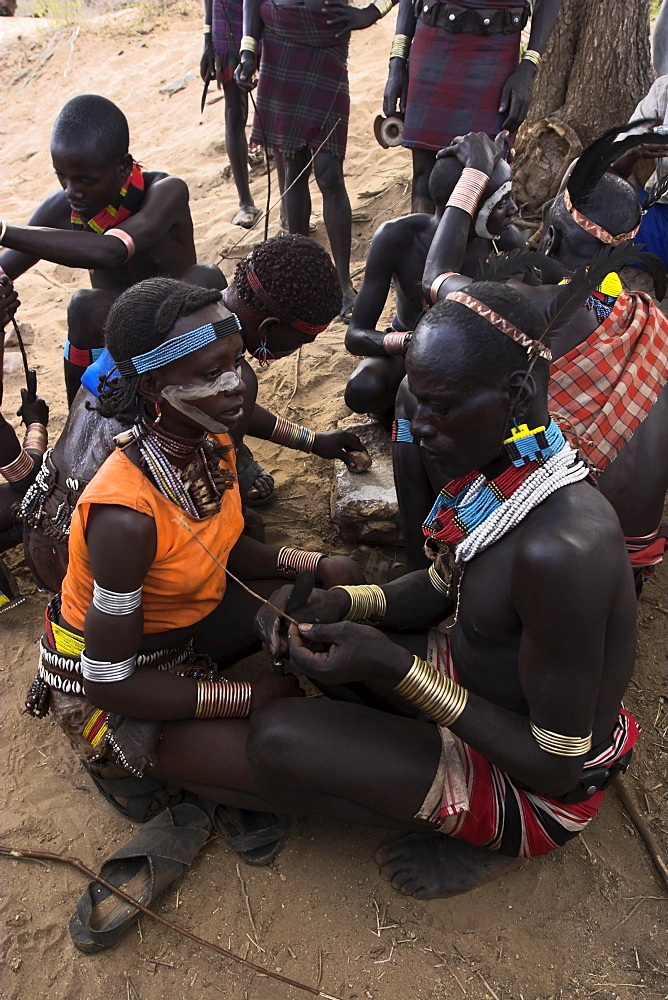 Face painting with a mixture of clay, oils and plant pigments, Hamer Jumping of the Bulls initiation ceremony, Turmi, Lower Omo valley, Ethiopia, Africa