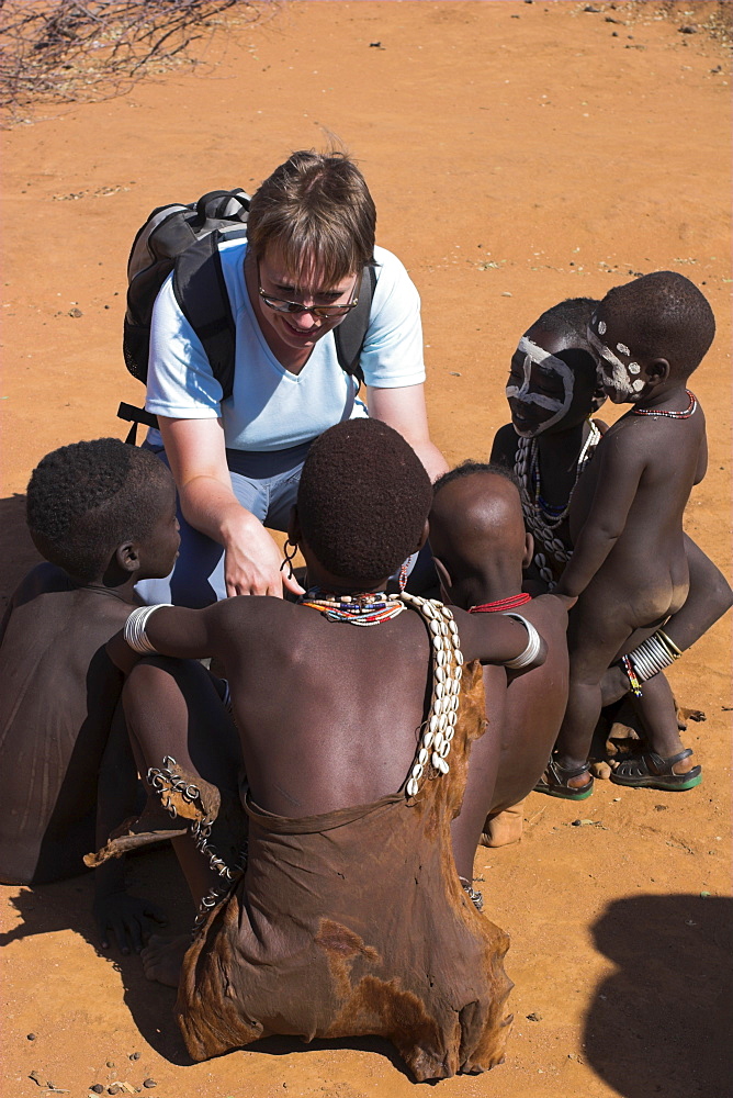 Tourist with Hamer (Hamar) children, Dombo village, Lower Omo Valley, Ethiopia, Africa