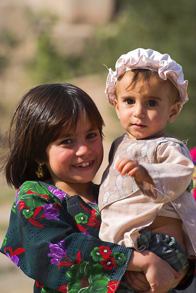 Aimaq girl holding baby, Pal-Kotal-i-Guk, between Chakhcharan and Jam, Afghanistan, Asia