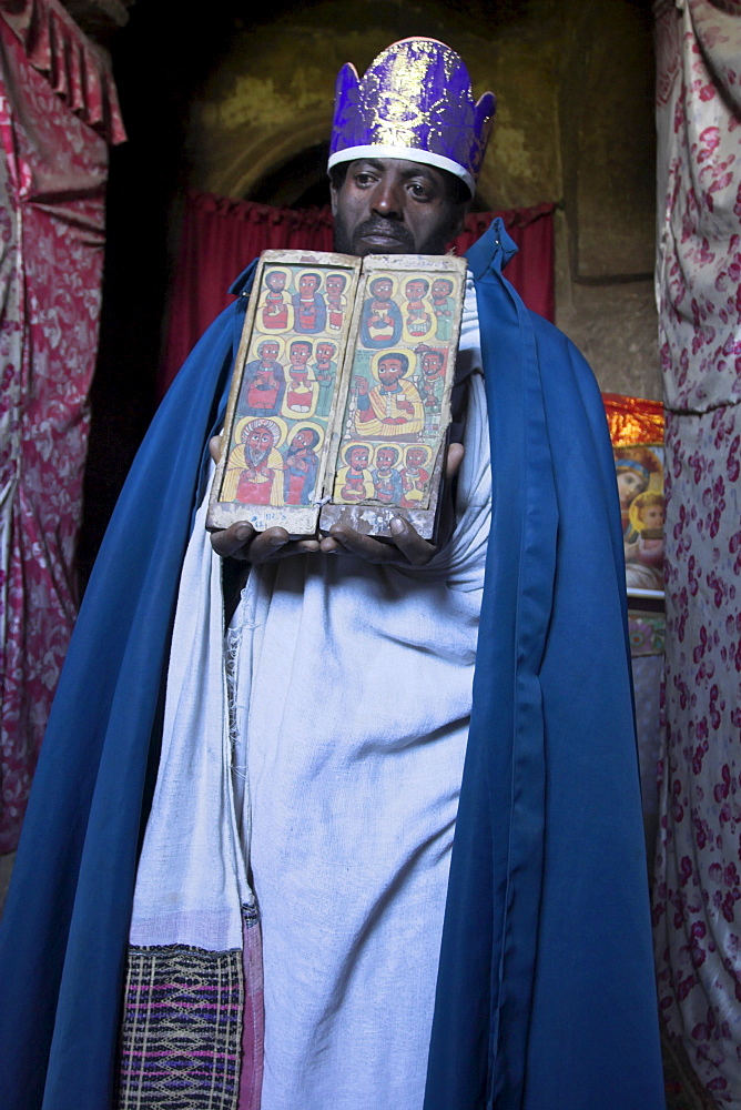 Priest holding ancient manuscript, Ashetan Maryam, Lalibela, Ethiopia, Africa