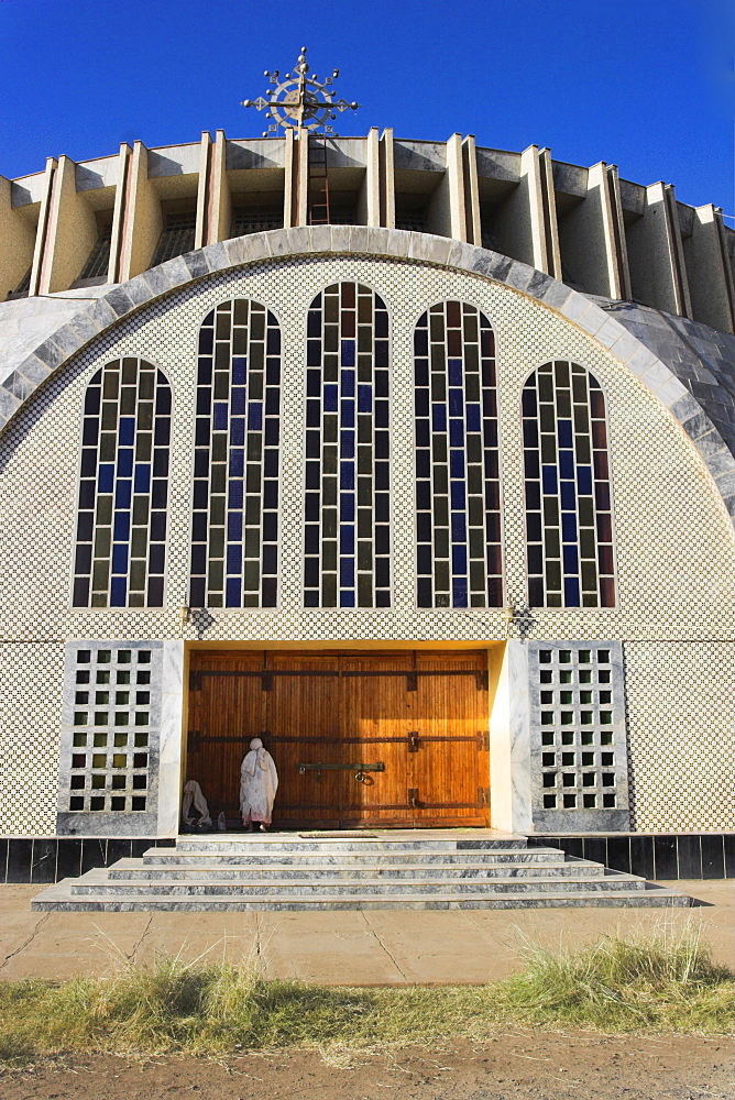 Pilgrim at doors of St. Mary of Zion new church, built by Haile Selassie in the 1960s, Axum, Ethiopia, Africa