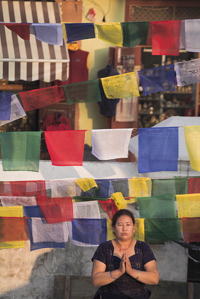 A woman praying during Lhosar (Tibetan and Sherpa New Year festival), Bodhnath Stupa, Bagmati, Kathmandu, Nepal, Asia