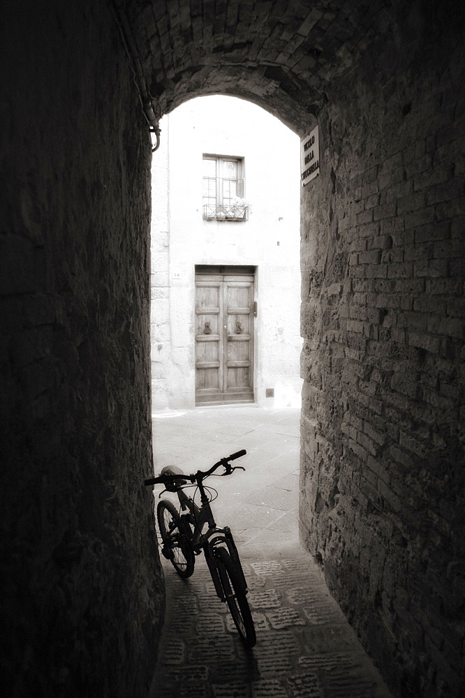 Infra red image of a bicycle in shady alleyway, San Quirico d'Orcia, Tuscany, Italy, Europe